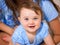 Newborn baby girl smiling with two lower teeth.