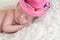 Newborn Baby Girl Wearing a Fancy Pink Hat