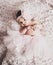 Newborn baby girl wearing a pink ballerina tutu