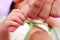 Newborn baby gripping mothers finger