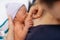 Newborn baby in hospital after just being born, mother holding him and breastfeeding in hospital bed