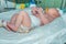 Newborn baby on infant warmer system in neonatal intensive care unit