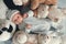 Newborn baby laying with five teddy bears on blanket