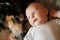 Newborn Baby Laying with Pet German Shepherd Dog
