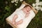 Newborn baby outside in the grass