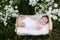 Newborn baby outside in the grass
