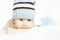 Newborn baby portrait in blue woolen hat close up