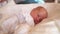 newborn baby sleep. boy infant sleep lies in a child bed. happy family birthday closeup baby concept. cute baby close up