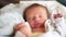 newborn baby sleep. boy infant sleep lies in a child bed. happy family birthday closeup baby concept. cute baby close up