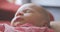 Newborn baby sleeping on father`s lap 4K