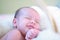 Newborn baby sleeping and grinning