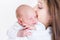 Newborn baby sleeping on his mother\'s shoulder