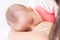 Newborn baby sleeping in mother breast. Adorable infant kid. Child and mom closeness.