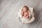 Newborn Baby Sleeping in a Wire Basket