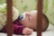 A newborn baby sleeps in his bed. Healthy sleep. Baby lying in the bed with green bedding