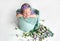 A newborn baby sleeps sweetly in a bucket surrounded by flowers