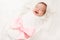 Newborn Baby Smile, New Born Girl Smiling Wrapped by Ribbon Bow