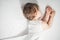 Newborn baby sweet sleeping on a white bed