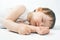 Newborn baby sweet sleeping on a white bed