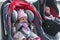 Newborn baby twins girl sitting in a car seat