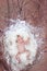 Newborn baby with white feather in nest. Portrait of adorable ne