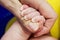 Newborn babys hand holding mothers finger. Taking care of a mother for her child. Family concept. Selected focus