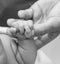 Newborn child holds father`s finger, close-up