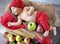 Newborn child sleeping on the box of apples