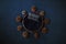 Newborn dark blue background - wooden bowl with blue faux fur, pine cones and pillow on dark background