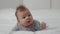 Newborn Development. Portrait Of Adorable Infant Baby Relaxing On Bed At Home