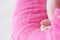 Newborn feet closeup, baby girl heels on pink background of mohair blanket