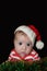 Newborn funny Santa baby with dumbfounded face isolated on black