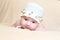 Newborn girl in white cap with flouwers