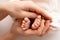 A newborn holds on to mom& x27;s, dad& x27;s finger. Hands of parents and baby close up. A child trusts and holds her tight