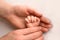 A newborn holds on to mom& x27;s, dad& x27;s finger. Hands of parents and baby close up. A child trusts and holds her tight