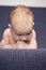 Newborn Ideas. Closeup Shoot of Sad Male Caucasian Newborn Lying On Blue Couch Indoors