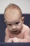 Newborn Ideas. Macro Shoot of Curious Male Caucasian Newborn Lying On Blue Couch Indoors