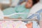 Newborn infant baby girl sleeping on blurred mother in ho
