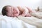 Newborn infant baby portrait first day life sleeping on diapers