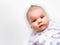 Newborn infant baby portrait on white grey background.