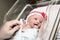 Newborn Infant Girl in Bassinet in Hospital