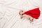 Newborn labrador puppy with red superhero cape sleeping on white