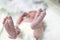 Newborn little baby feet in hospital. newborn baby girl in baby hat. premature baby