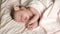 Newborn little baby girl is sleeping on the bed, sweet dreams of little baby, healthy sleep.