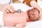 Newborn medical exam - doctor checking heart beat and lungs with stethoscope in pediatric clinic