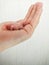 A newborn mouse lies on a human hand. Decorative bald rodent closeup