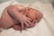 newborn in the postpartum crib still covered in vernix caseosa and with the baby hat for the first time