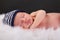 Newborn sleeping with hat fuzzy blanket