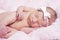 Newborn sleeping naked on her side.