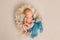 Newborn sleeping on a scarf in basket, topview